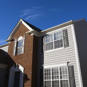 Home exterior featuring brick and vinyl siding 