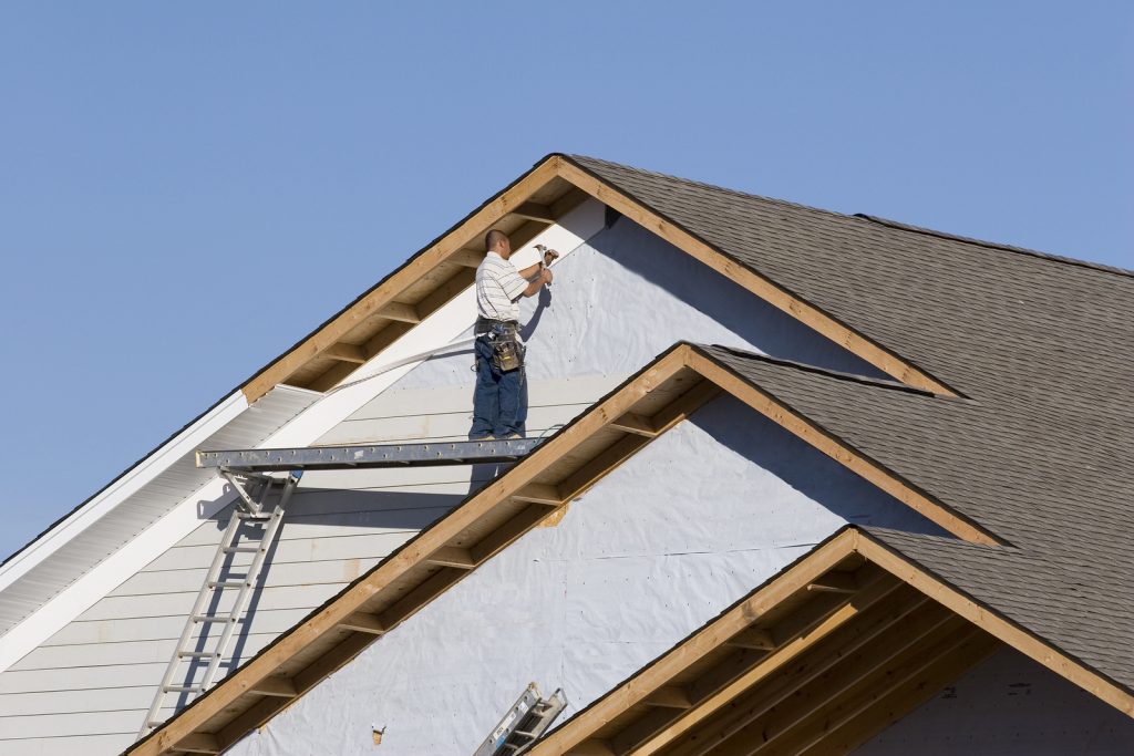 Man installing a roof.