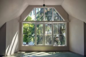 Window Contractors Pewaukee WI Large window letting in a lot of light in an empty room